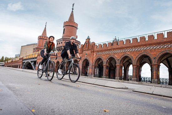 Paar auf Rennrädern vor der Berliner Oberbaumbrücke